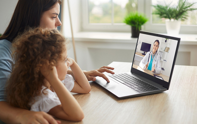 Healthy mother and child enjoying digital era, having online telemedicine consultation with remote doctor